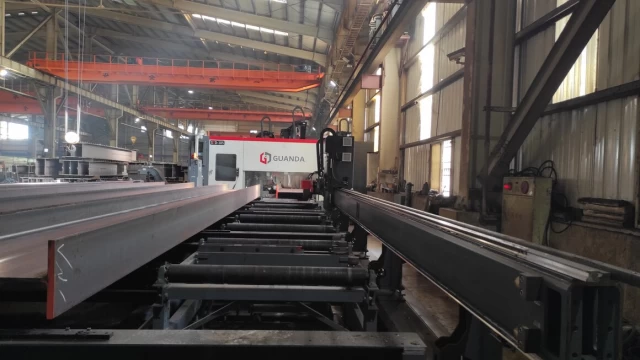 Beam drilling process in action within a factory.