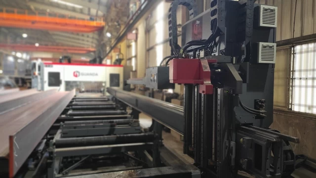 Advanced beam drilling machine from Guanda in a factory setting.