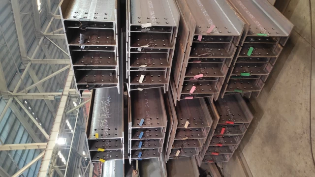 Stacked steel beams with tags by Guanda International Machinery