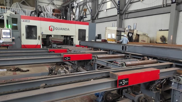 Close-up of the steel beam drilling process.