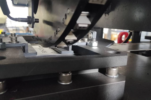 Detailed view of the cutting and marking section of the STM machine, highlighting precise engineering by Guanda International Machinery.